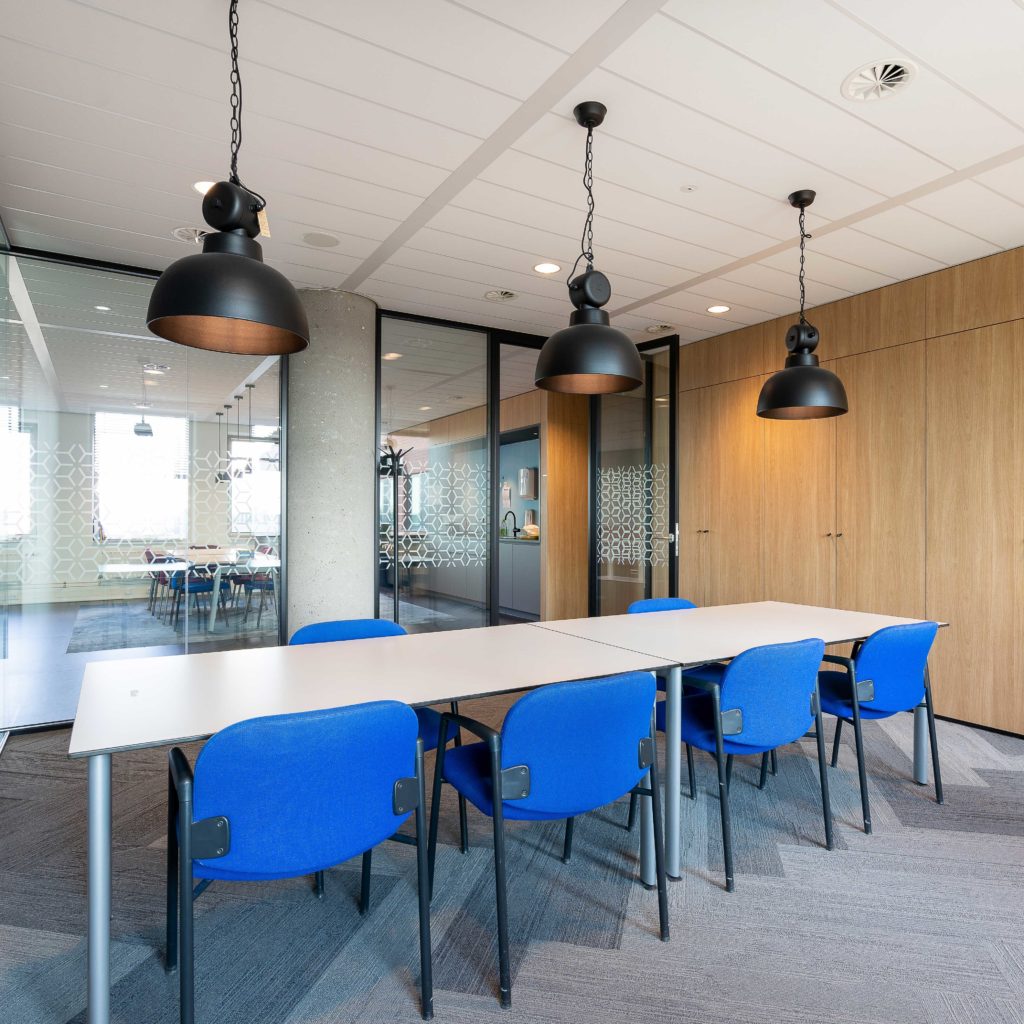 meeting-room-interior-modern-office-with-long-wooden-table-chairs-around-it
